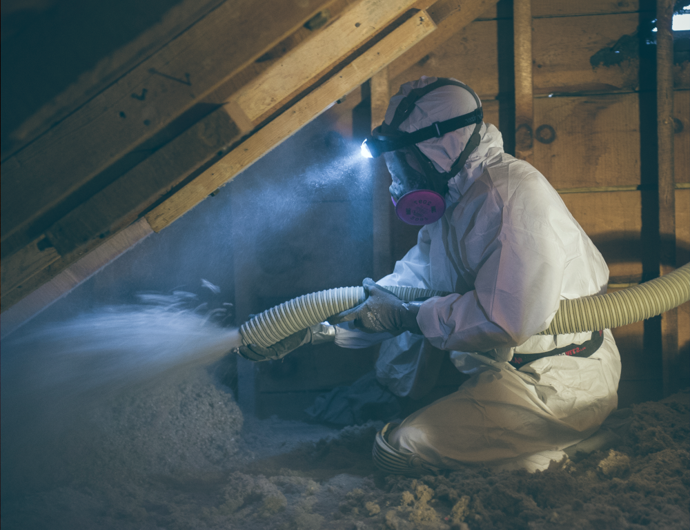 Person Blowing insulation in attic